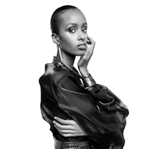 a black and white photo of a woman in a black dress