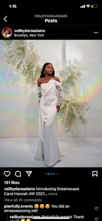 a woman is posing in a white dress