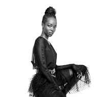 a black and white photo of a woman in a tulle skirt