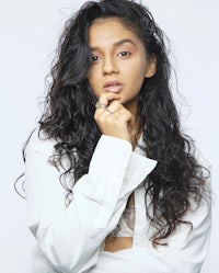 a woman in a white shirt posing for a photo