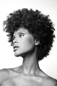 black and white photo of a woman with afro hair