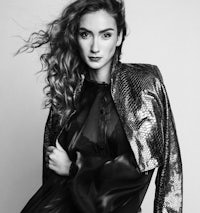 a black and white photo of a woman in a leather jacket