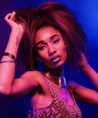 a woman with afro hair posing on stage