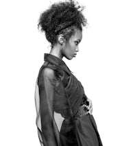 a black and white photo of a woman with an afro