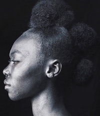 a black woman with an afro hairstyle in black and white