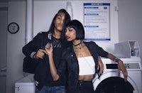 a man and woman posing in front of a washing machine