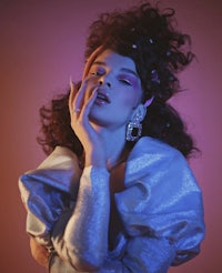 a woman in a silver dress posing for a photo