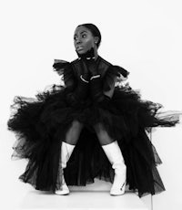 a black and white photo of a woman in a tutu