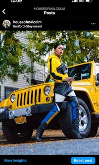 a woman is standing next to a yellow jeep