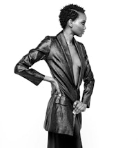 a black and white photo of a woman in a leather jacket