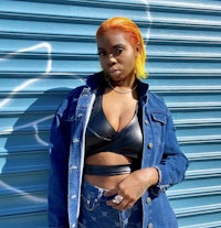 a woman wearing a denim jacket and jean shorts